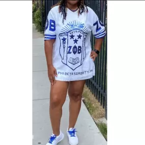 Zeta Phi Beta sorority sequence dress in white, featuring a large graphic symbol.